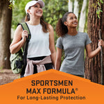 Two smiling people hiking in a wooded area above an orange banner that reads Sportsmen Max Formula for long-lasting protection