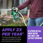 Person holding an Ortho WeedClear sprayer attached to a garden hose with overlay text advising to apply twice per year