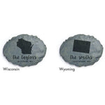 Two faux-stone garden plaques side by side showing Wisconsin and Wyoming silhouettes with sample family names and city text