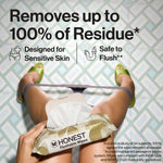 Top-down lifestyle shot of a person holding an open Honest Flushable Wipes pack above patterned floor, marketing text visible