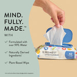 Hand lifting a wipe from an Honest Little Flushables pack with callouts about formulation and plant-based wipe benefits