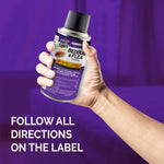 Hand holding a Hot Shot Bedbug & Flea Fogger canister over a purple background with label reminder to follow directions