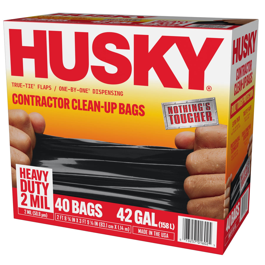 Three-quarter view of Husky contractor clean-up bags retail box showing logo, hands stretching a black bag and product callouts