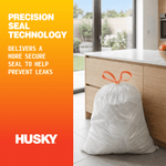 Lifestyle-style Husky graphic showing a tied white trash bag beside kitchen cabinets and text about precision seal technology