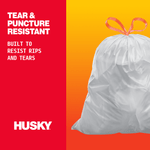Close-up Husky feature graphic with tied white trash bag and text noting tear and puncture resistant