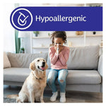 Hypoallergenic banner above a child sitting on a couch blowing their nose while a golden retriever sits nearby