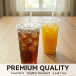 Two clear plastic cups with lids and straws on a wood table, one filled with iced cola and one with orange drink