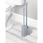iDesign gray toilet plunger and brush set shown next to a toilet on a marble-look bathroom floor