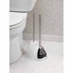 White plastic holder with stainless handles showing black plunger cup and brush next to toilet