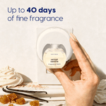 Hand holding a Scent Theory refill bottle as it is inserted into the plug-in diffuser with vanilla beans and dessert props and text 'Up to 40 days'.