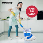 Lifestyle image of a woman mopping a kitchen floor with a blue InstaMop bucket and mop, spin dry graphic