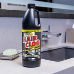 Instant Power Hair Clog Remover bottle placed on a bathroom sink counter near a faucet and soap dish