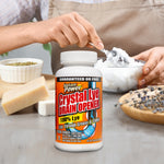 Instant Power Crystal Lye Drain Opener bottle placed in a kitchen-style scene with hands mixing ingredients in the background.
