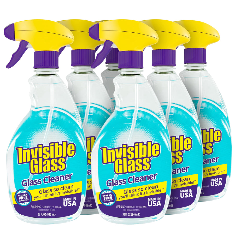 Six clear spray bottles of Invisible Glass cleaner with teal liquid and yellow triggers shown together on white background
