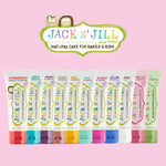 Row of Jack N' Jill toothpaste tubes in many flavors under the Jack N' Jill logo on a pink background