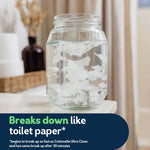 Glass jar of water with disintegrating white wipe pieces demonstrating flushable breakdown feature