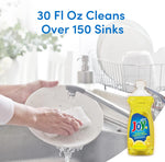 Lifestyle image of hands washing a plate at a sink with a Joy Ultra lemon dish liquid bottle pictured at the lower right