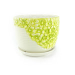 Close-up of a K-Cliffs lime-yellow floral ceramic planter showing raised flower texture and matching saucer on white background.