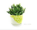 Single K-Cliffs lime-yellow floral ceramic planter filled with dense faux greenery, shot on a white background.