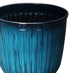 Top-side view of an aqua ribbed planter showing glossy dark interior and vertical textured glaze drips