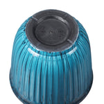 Underside view of aqua ribbed planter turned upside down showing molded plastic base with recycling symbols