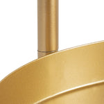 Close-up detail of gold metal tray rim and supporting post on a tri-level plant stand showing finish texture