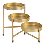Angled view of a gold three-tier metal plant stand with circular trays and tripod-style legs