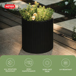 Keter graphite rattan cylinder planter with plants, brand logo and icons promoting weather resistance
