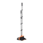 Black and orange upright broom and dustpan set with telescoping metal handle standing on white background.