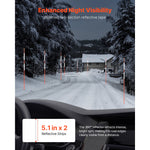 Nighttime roadway scene with orange-and-white reflective marker poles lining a snowy road, with visibility callouts and measurements.