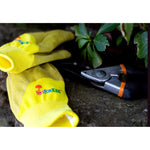 Yellow-green kids gardening gloves laid on a stone surface next to pruning shears, showing JustForKids logo