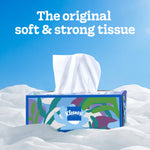 Kleenex patterned tissue box on soft white fabric with a tissue pulled up and headline 'The original soft & strong tissue'