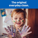 Child with paint-covered hands and face smiling beneath 'The original everyday clean' Kleenex banner
