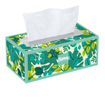Single rectangular Kleenex tissue box with green leafy botanical pattern and one tissue partially pulled out.