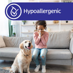 Hypoallergenic banner over a living room scene showing a child blowing their nose and a golden retriever on the sofa
