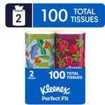 Two Kleenex Perfect Fit decorative tissue canisters in floral and pomegranate patterns with packaging showing '100 total tissues'.