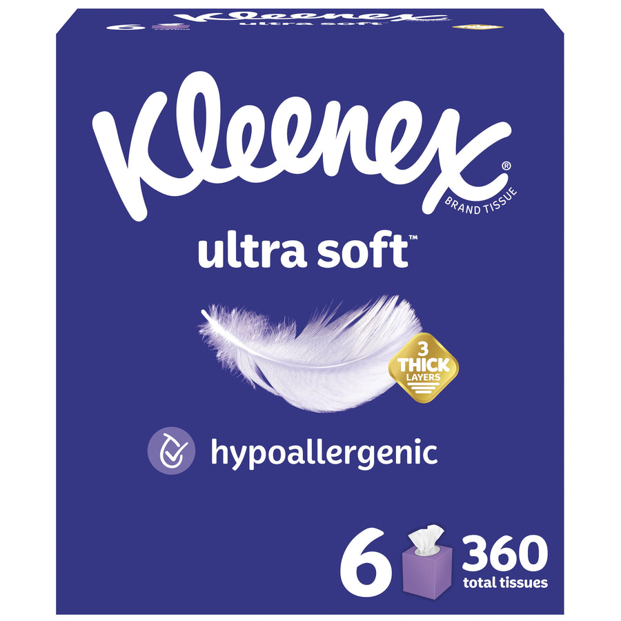 Front-facing Kleenex Ultra Soft cube tissue box design in deep blue with feather graphic and hypoallergenic badge