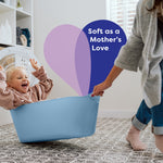 Lifestyle image of a child in a laundry basket being pulled by an adult with overlay text ‘Soft as a Mother’s Love’