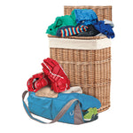 Laundry basket, duffel bag and clothing piled together as a lifestyle scene to illustrate odor-prone items for deodorizer use.