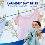 Lifestyle image of a woman smelling a towel on a clothesline with text 'Laundry Day Bliss' and crisp linen scent claim