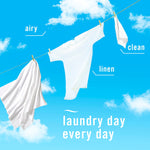 White laundry hanging on a clothesline against a blue sky with words airy, linen, clean and laundry day copy