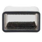 Close-up view into the open top of a white self-cleaning lint brush base showing inner textured pads