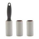 Three white lint roller refill tubes with one dark gray handle inserted, on white background