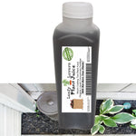 Plastic squeeze bottle of dark liquid with a Leafy Lovers Plant Juice label over a garden bed background