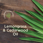 Wood background with long green lemongrass leaves and text 'Lemongrass & Cedarwood Oil'