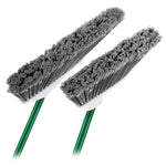 Close-up of two broom heads with dense gray bristles attached to green handles on white background