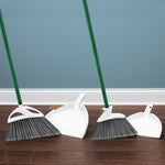 Two Libman angle broom and dustpan sets staged against a blue wall and wood floor for lifestyle display