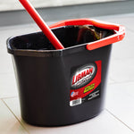 Close three-quarter view of black Libman bucket showing red handle and label, photographed on floor