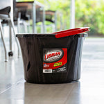 Black Libman utility bucket on tiled floor with red handle folded over rim and brand label on front