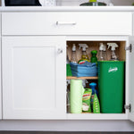 Cabinet interior styled with cleaning supplies and a tall green Libman rinse-and-wring bucket stored inside